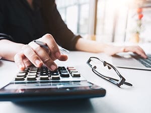 Doing taxes with computer in the background