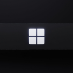 Close-up of a backlit Windows logo on a dark surface, symbolizing the Microsoft Windows operating system.
