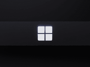 Close-up of a backlit Windows logo on a dark surface, symbolizing the Microsoft Windows operating system.