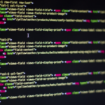 Close-up of computer screen displaying colorful HTML code, focus on a cursor within a text editor.
