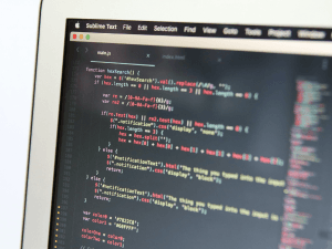 Close-up of code on a computer screen with Sublime Text editor in focus.