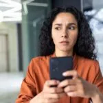 A woman concerned about a potential smishing text message