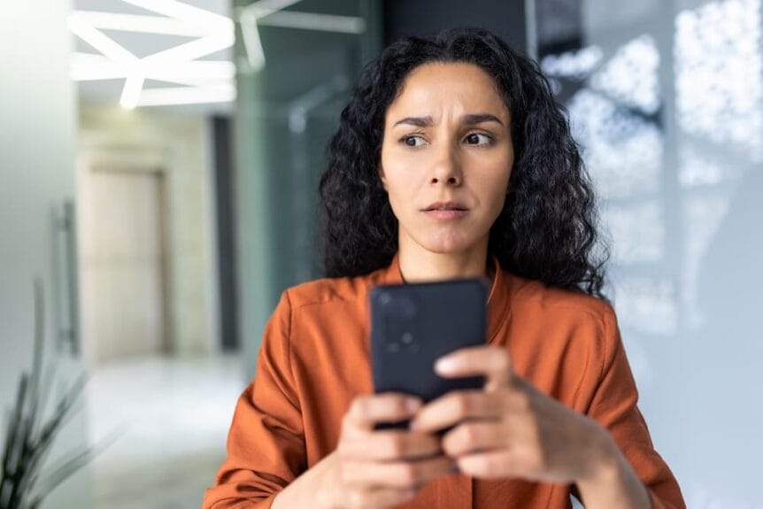 A woman concerned about a potential smishing text message