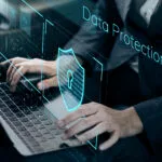 Person typing on a keyboard while their interaction is secured by data protection.