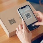 A woman scanning a QR code on a package
