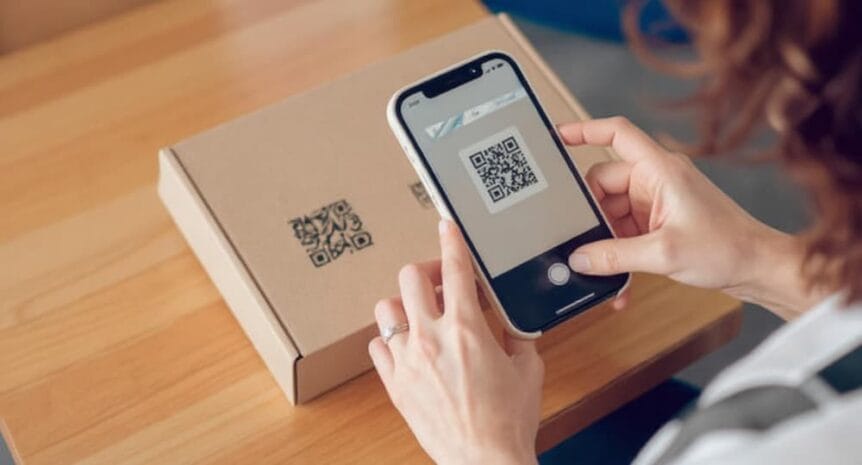 A woman scanning a QR code on a package